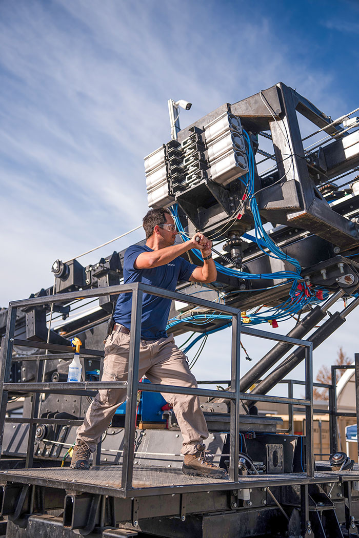 closeup of a tech setting up a firedome launcher.
