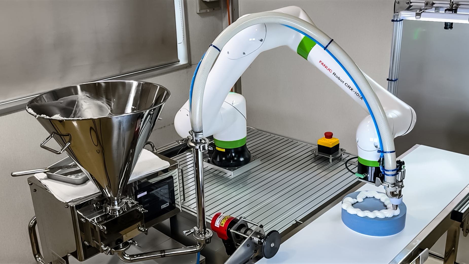 CRX-10iA dispensing icing on a moving cake conveyor