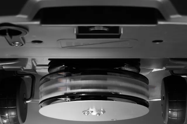 Underside view of a robotic lawn mower showing its rotating blades.